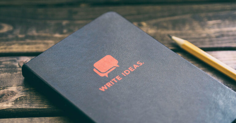 Notebook on desk with pencil